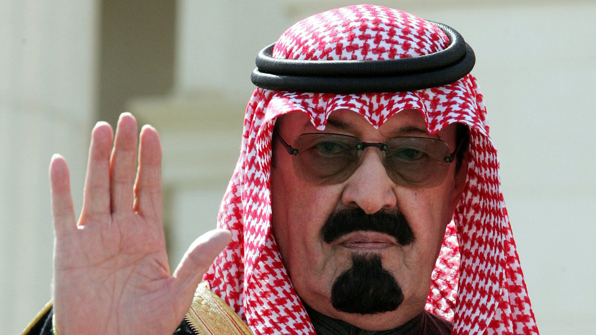 الملك عبد الله يلوح للضيوف لدى وصوله لافتتاح مؤتمر في الرياض، 5 فبراير/شباط 2005 