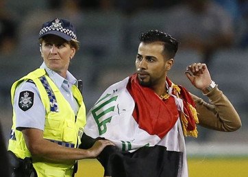 أحد مشجعي جماهير المنتخب العراقي يتسلل إلى أرض ملعب "كانبرا" أثناء مباراة فلسطين