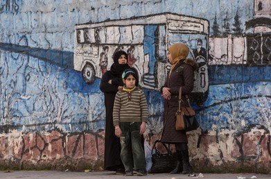 نساء في أحد شوارع بلدة أحرس المحررة من براثن الإرهابيين