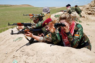 المحاربة الكردية العراقية حسيبة نوزاد (24 عاما) والمحاربة اليزيدية أسماء ضهير (21 عاما) بالقرب من خط الجبهة في ضواحي مدينة الموصل، 20 أبريل/نيسان 