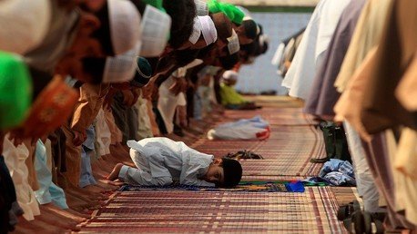 طفل يشارك في أداء صلاة العيد في باكستان